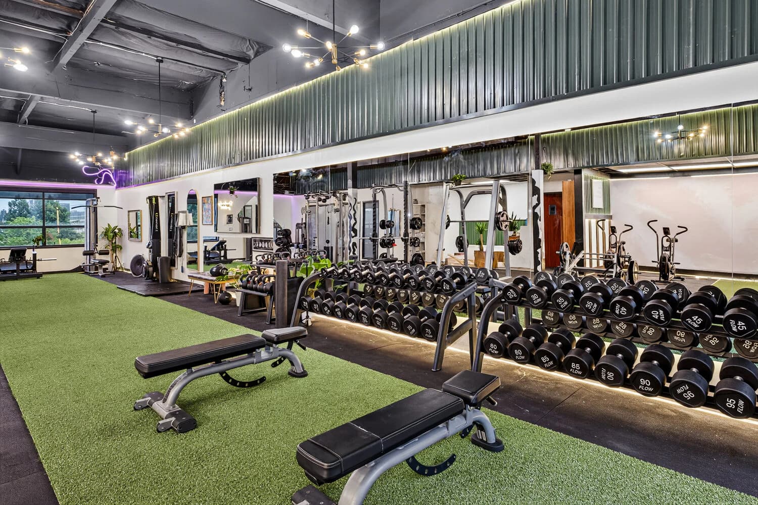 Open training floor with turf and racks